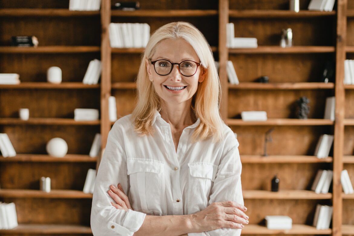 businesswoman-librarian-psychologist-teacher-with-arms-crossed-looking-at-camera-in-library-office.jpg