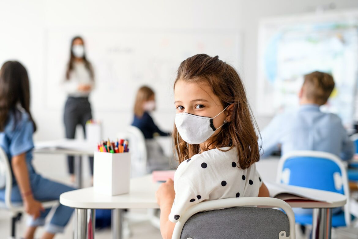 child-with-face-mask-back-at-school-after-covid-19-quarantine-and-lockdown.jpg