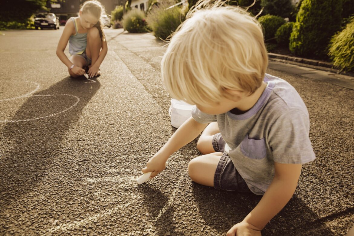 children-using-sidewalk-chalk-in-their-neighborhood.jpg