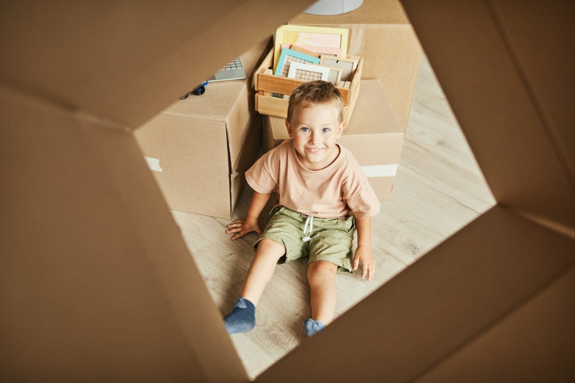 cute-kid-playing-with-box-in-new-home.jpg