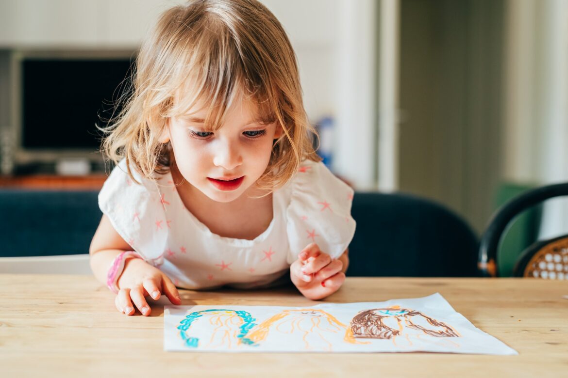 female-child-indoor-drawing-on-a-paper.jpg