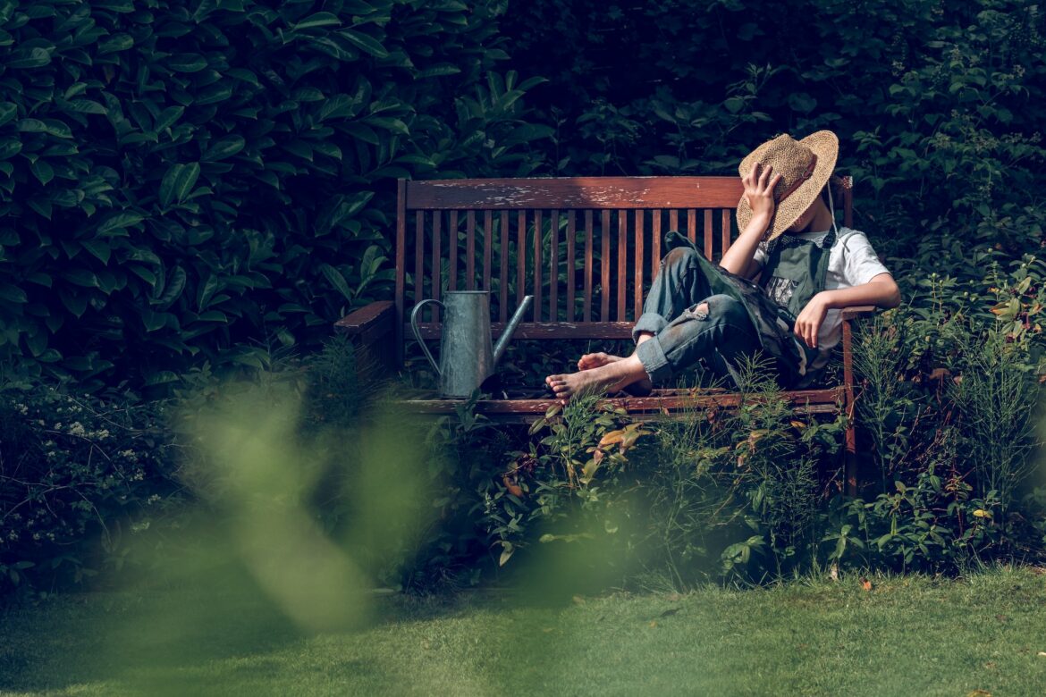 gardener-kid-resting-on-bench-after-work.jpg