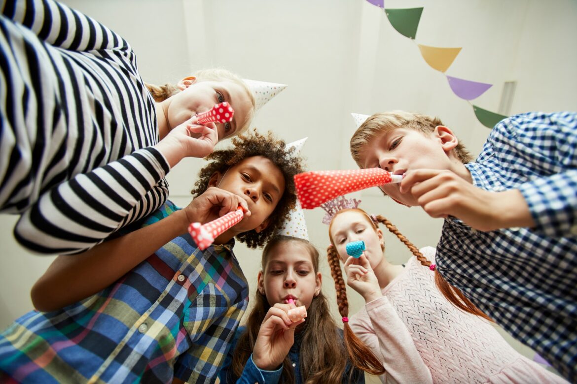 group-of-children-blowing-party-horns.jpg