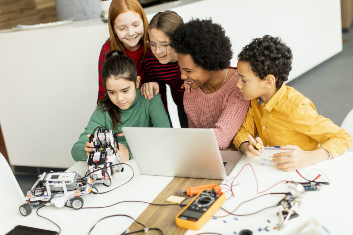 group-of-happy-kids-with-their-african-american-female-science-teacher-1.jpg