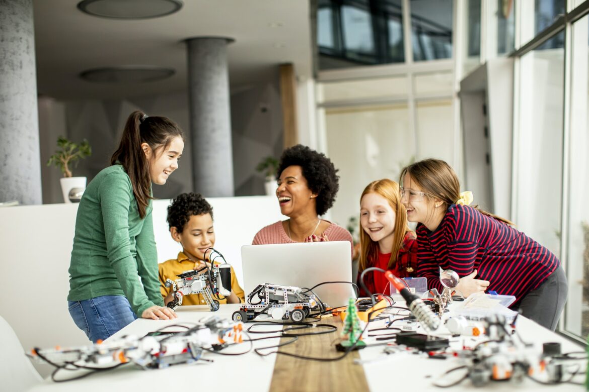 group-of-happy-kids-with-their-african-american-female-science-teacher.jpg