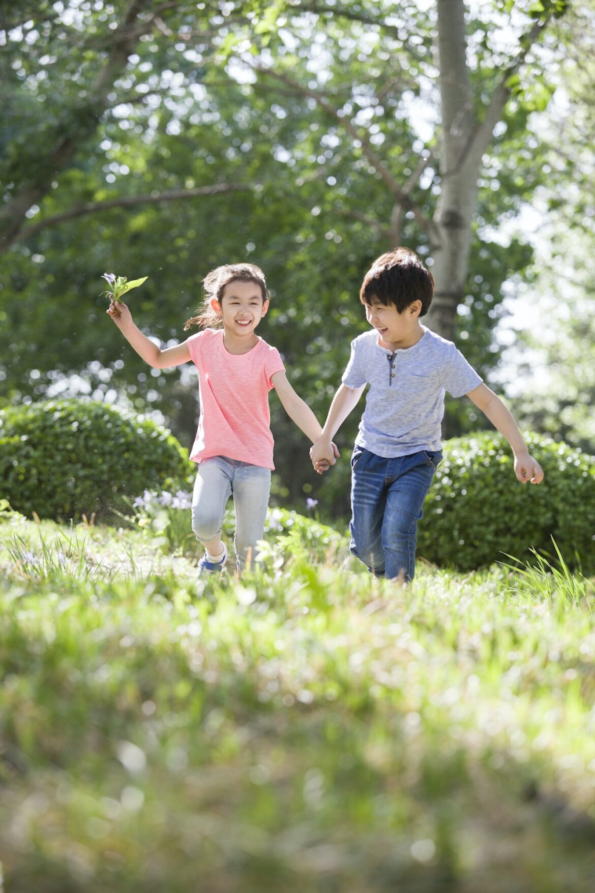 happy-children-holding-hands-running-in-woods.jpg