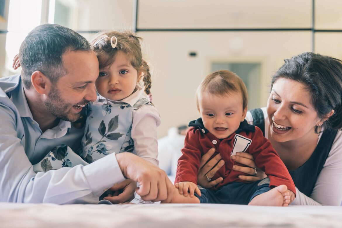 happy-family-with-two-kids-indoor-at-home-playing-together.jpg