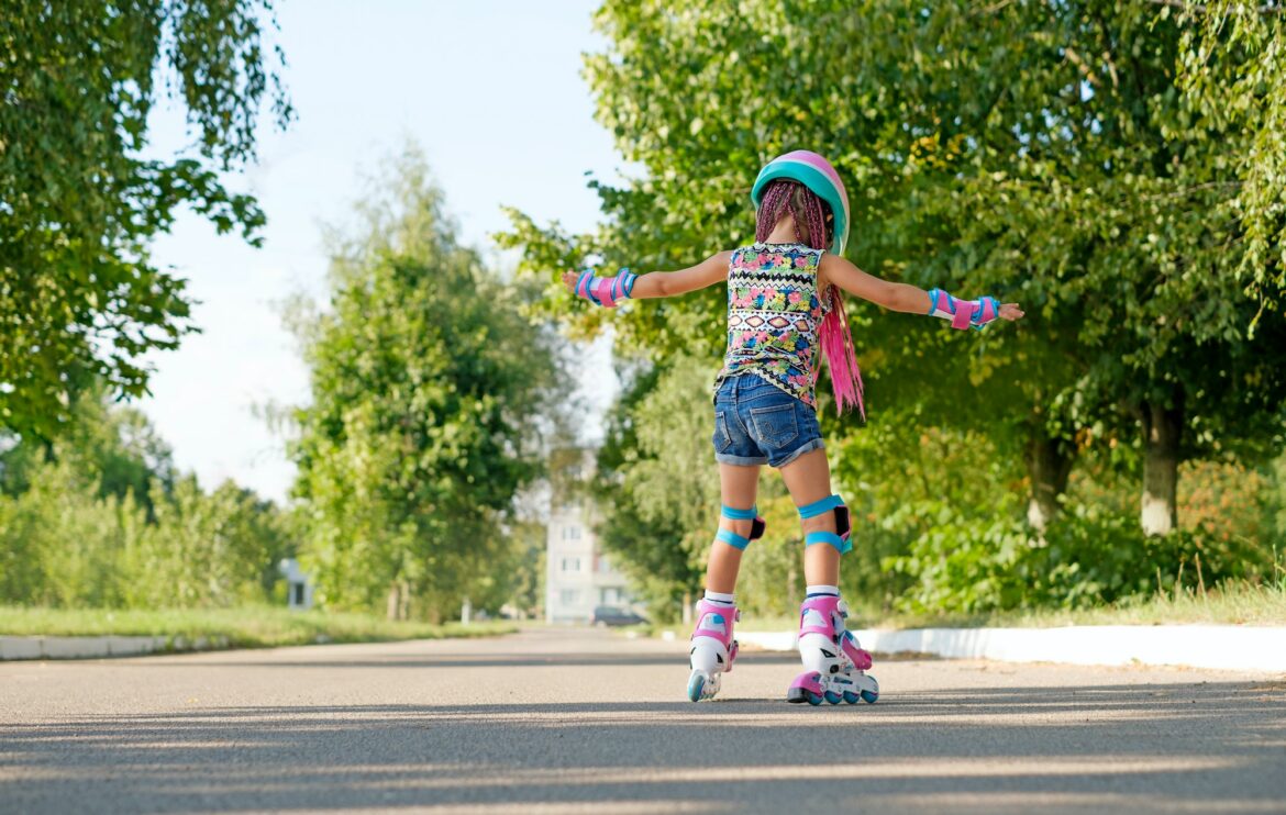 kid-tries-to-keep-and-not-fall-for-the-first-time-standing-on-roller-skates.jpg