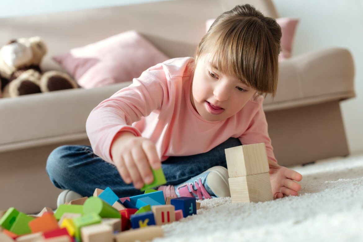 kid-with-down-syndrome-playing-with-toy-cubes.jpg