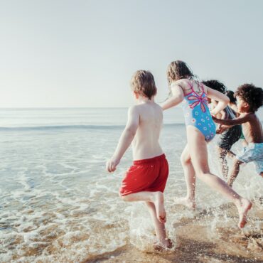 Kids at the beach summer vacation, vivid tone