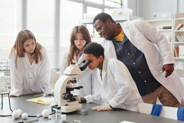 Kids using Microscope in Science Lab