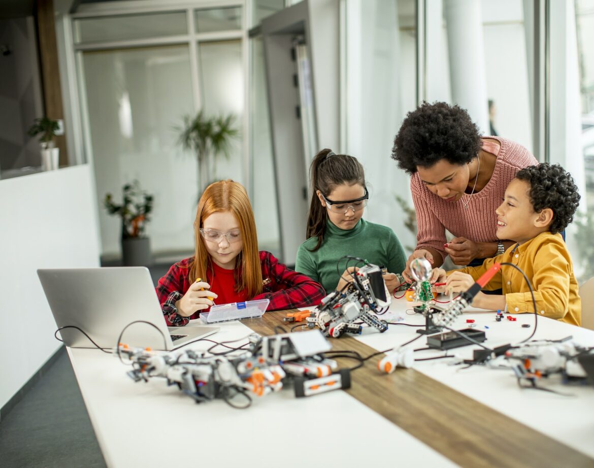 kids-with-their-african-american-female-science-teacher-with-laptop.jpg