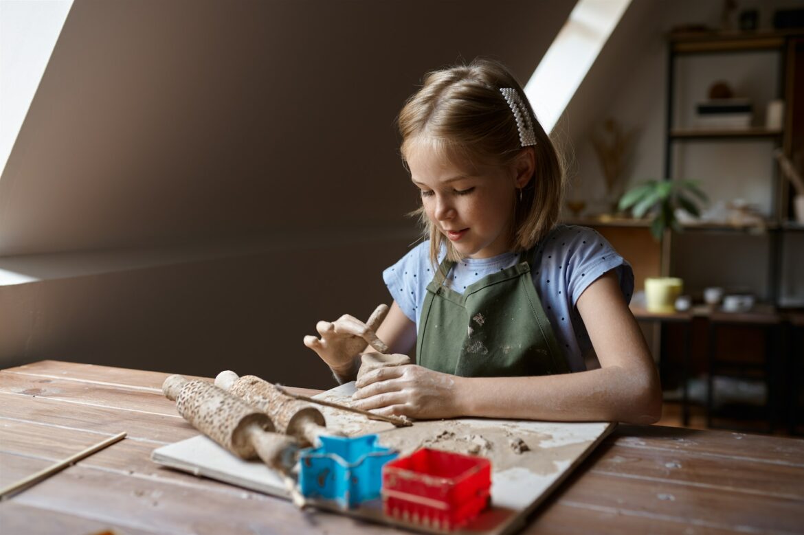 little-girl-works-with-clay-kid-in-workshop.jpg