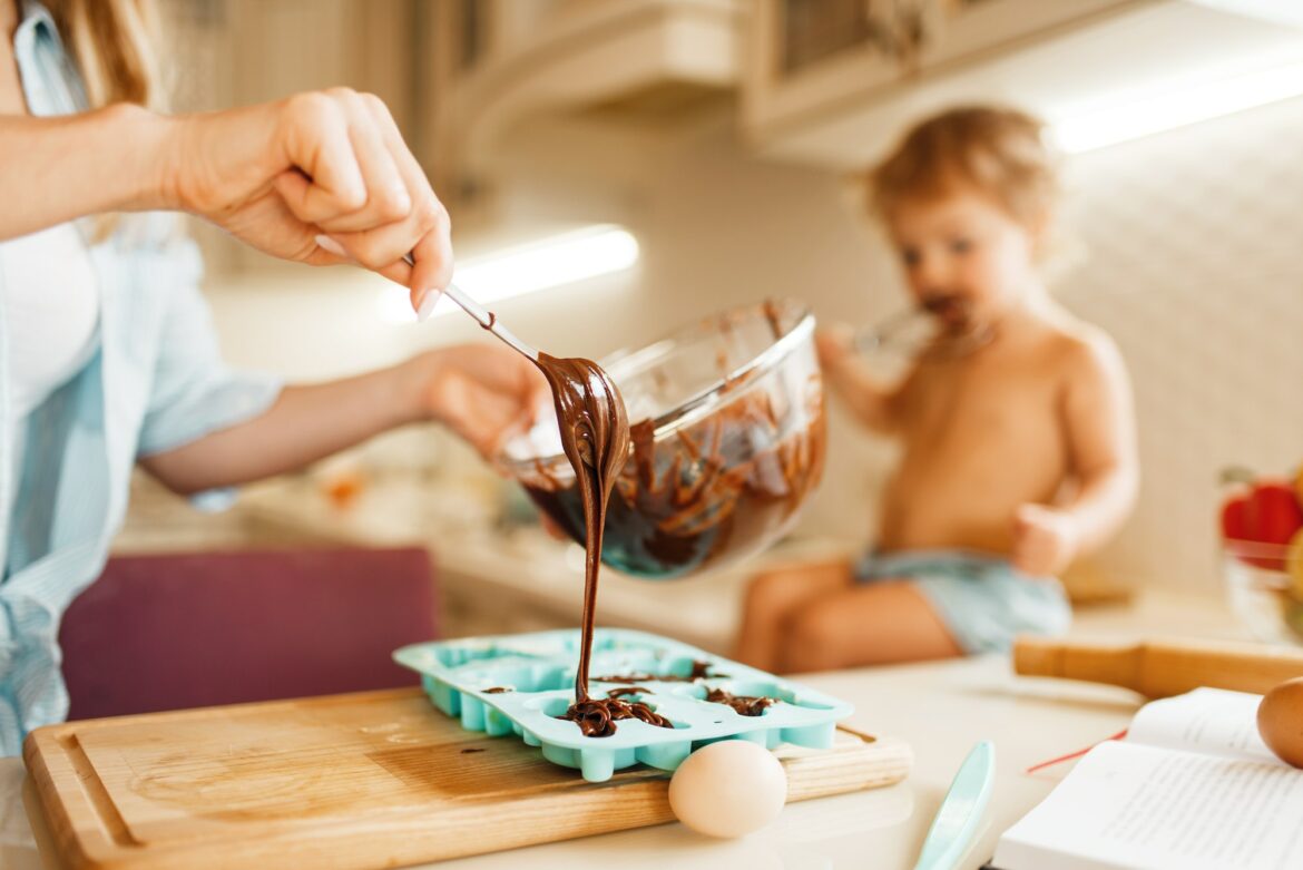 mother-and-kid-cooking-and-tastes-melted-chocolate.jpg