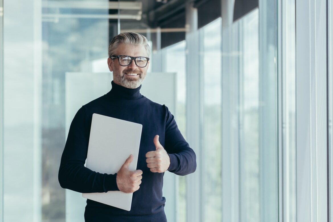 portrait-of-senior-and-experienced-teacher-gray-haired-university-teacher-by-the-window-smiling-and.jpg