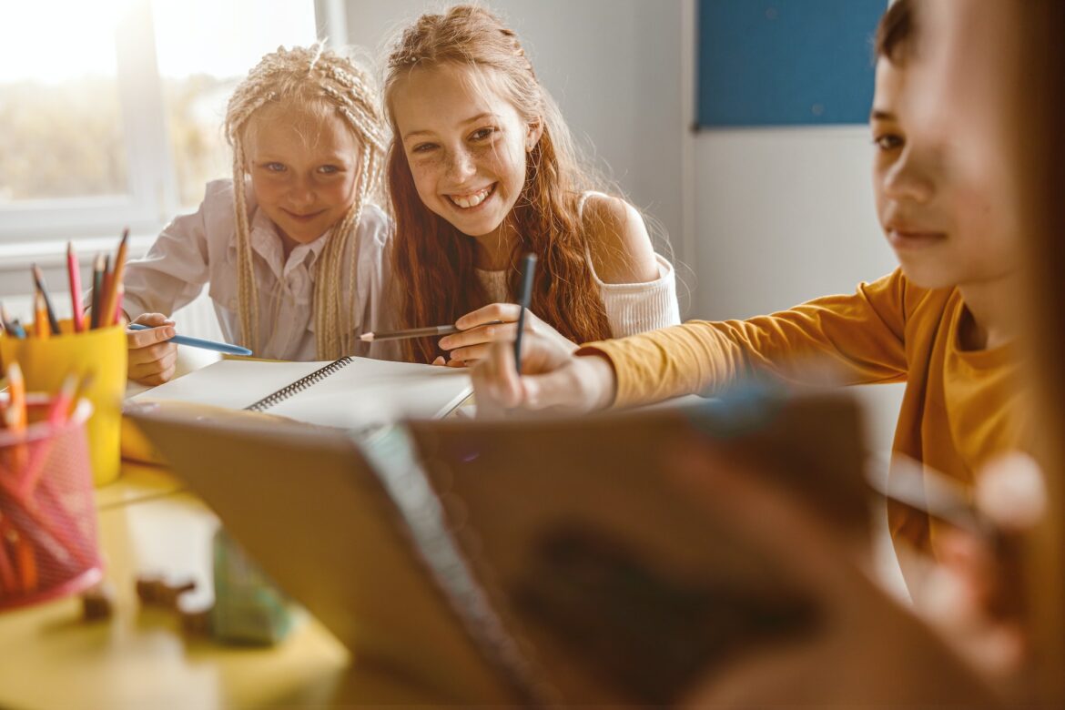 smiling-children-studying-at-school-and-sitting-at-the-table.jpg