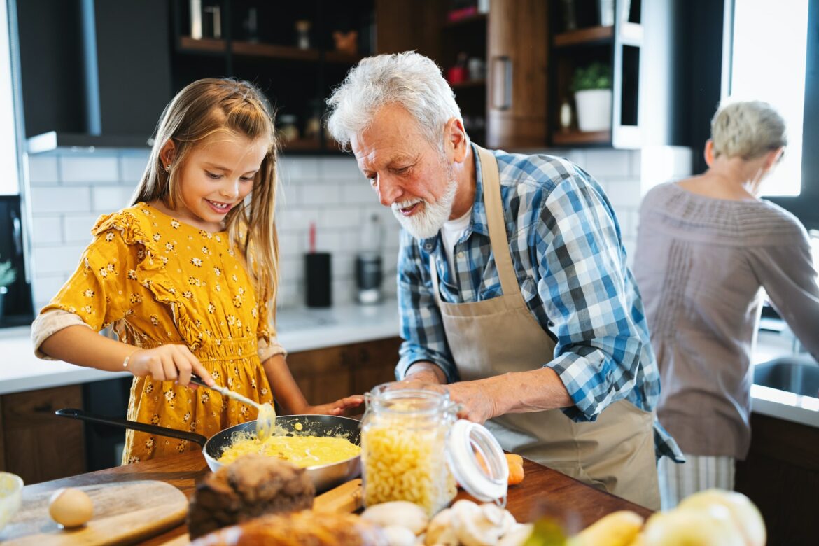 smiling-grandfather-helping-children-to-cook-in-the-kitchen.jpg