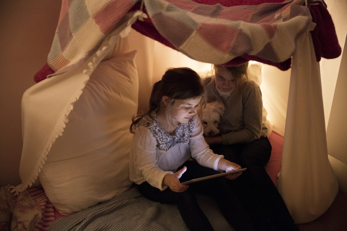 two-girls-with-dog-and-tablet-in-children-s-room.jpg