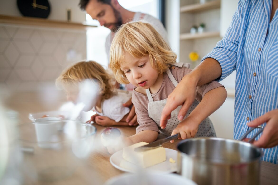 young-family-with-two-small-children-indoors-in-kitchen-preparing-food-.jpg